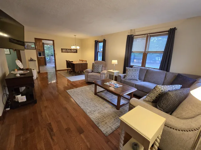 a living room with furniture and wooden floor