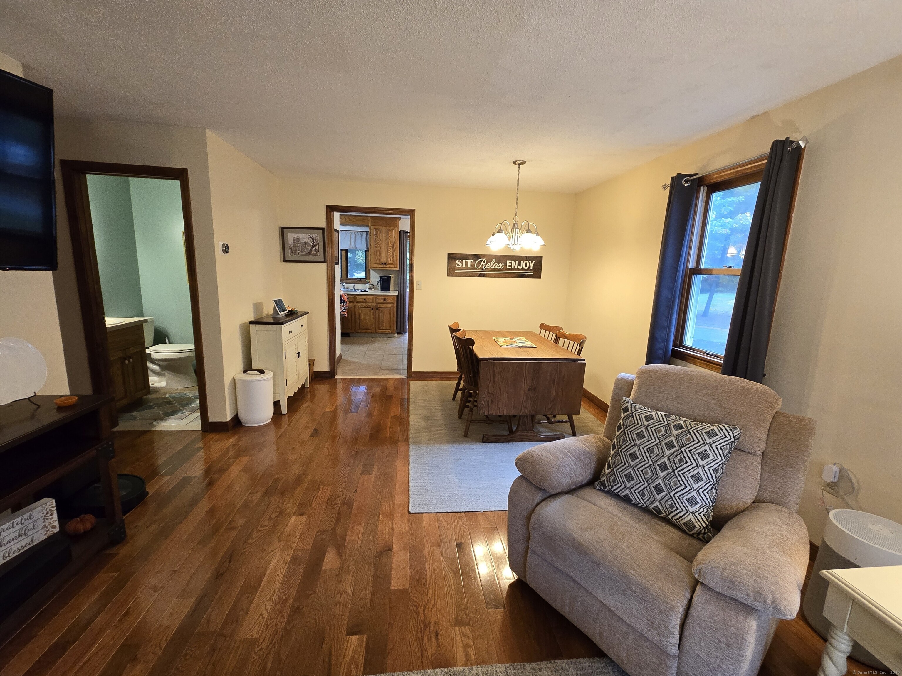 85 Oldefield Farms, Unit 85 Enfield, CT 06082 - Photo 9 of 36 a living room with furniture and a flat screen tv