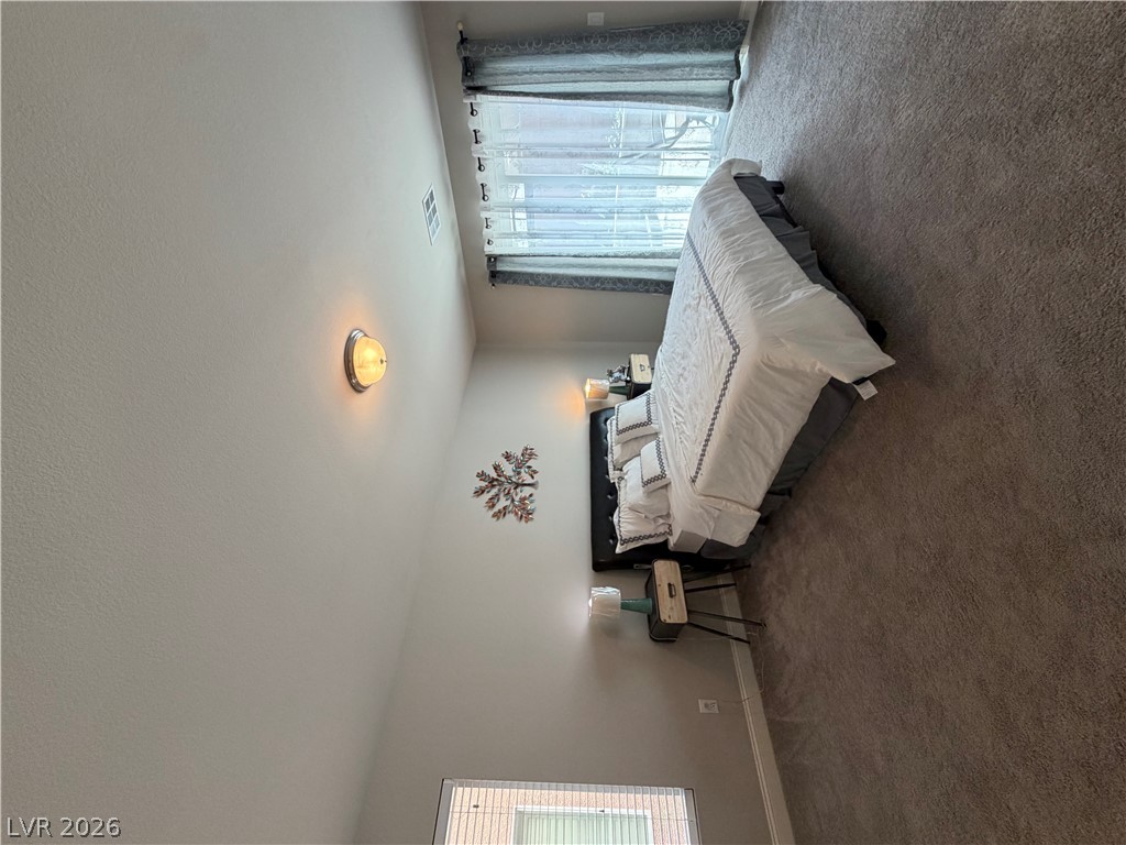 6385 Jackson Spring Road Las Vegas, NV 89118 - Photo 30 of 36 Restful retreat with plush carpeting and abundant natural light from wide windows.