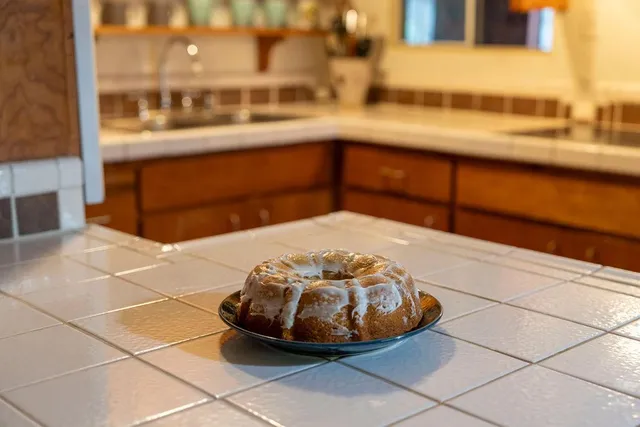 a bedroom with a bed and a flat tv screen on the dresser