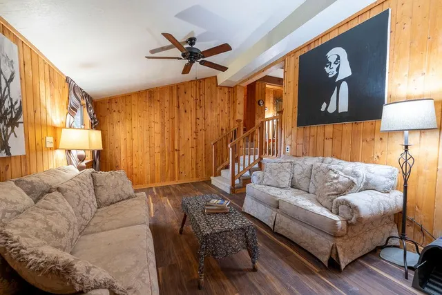a living room with furniture a rug and a window