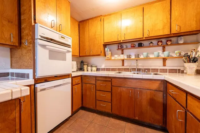 a view of a tables and chairs in a backyard
