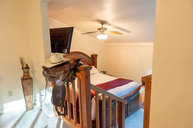 a bedroom with a bed a mirror and lamp