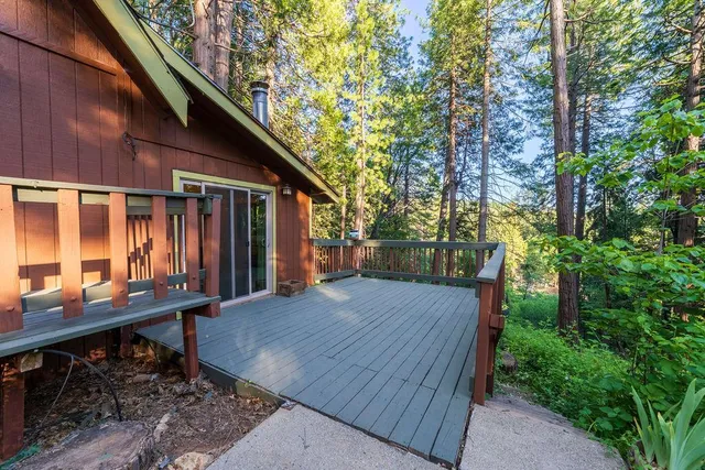 a backyard of a house with barbeque oven table and chairs