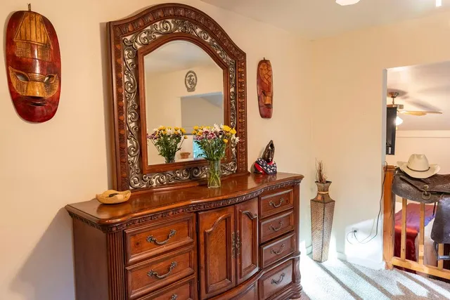 a view of a backyard with chairs and a fire pit
