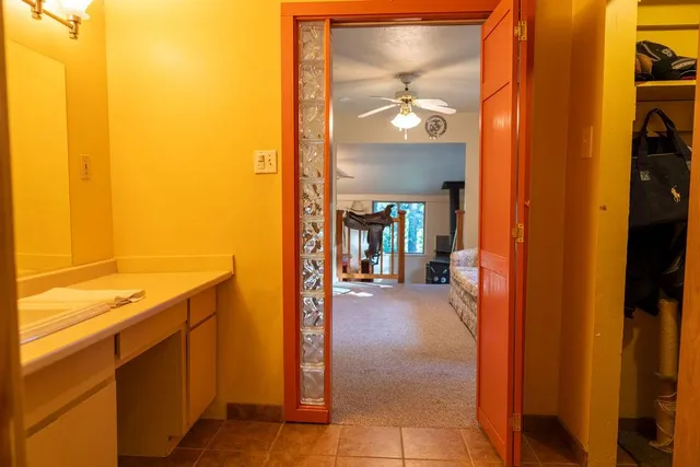 a view of a street sign under a large tree