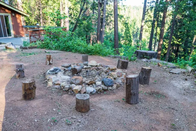 a view of a chairs and table in the patio in front of a house