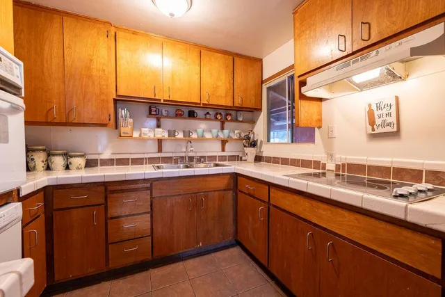 a living room with furniture a couch and next to a window