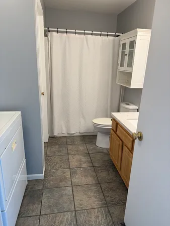 a bathroom with a toilet and a shower