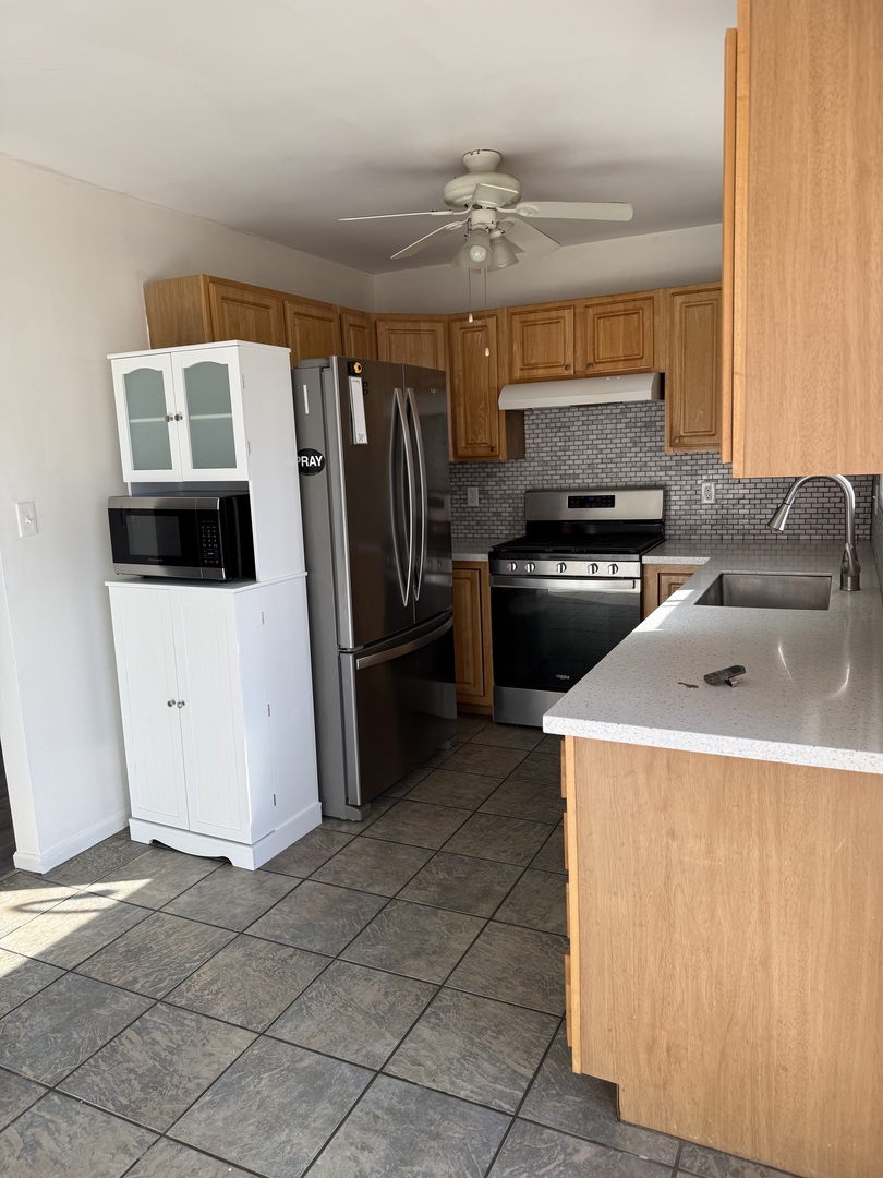 206 South 12th Street Rochelle, IL 61068 - Photo 5 of 14 a kitchen with a refrigerator sink and stove