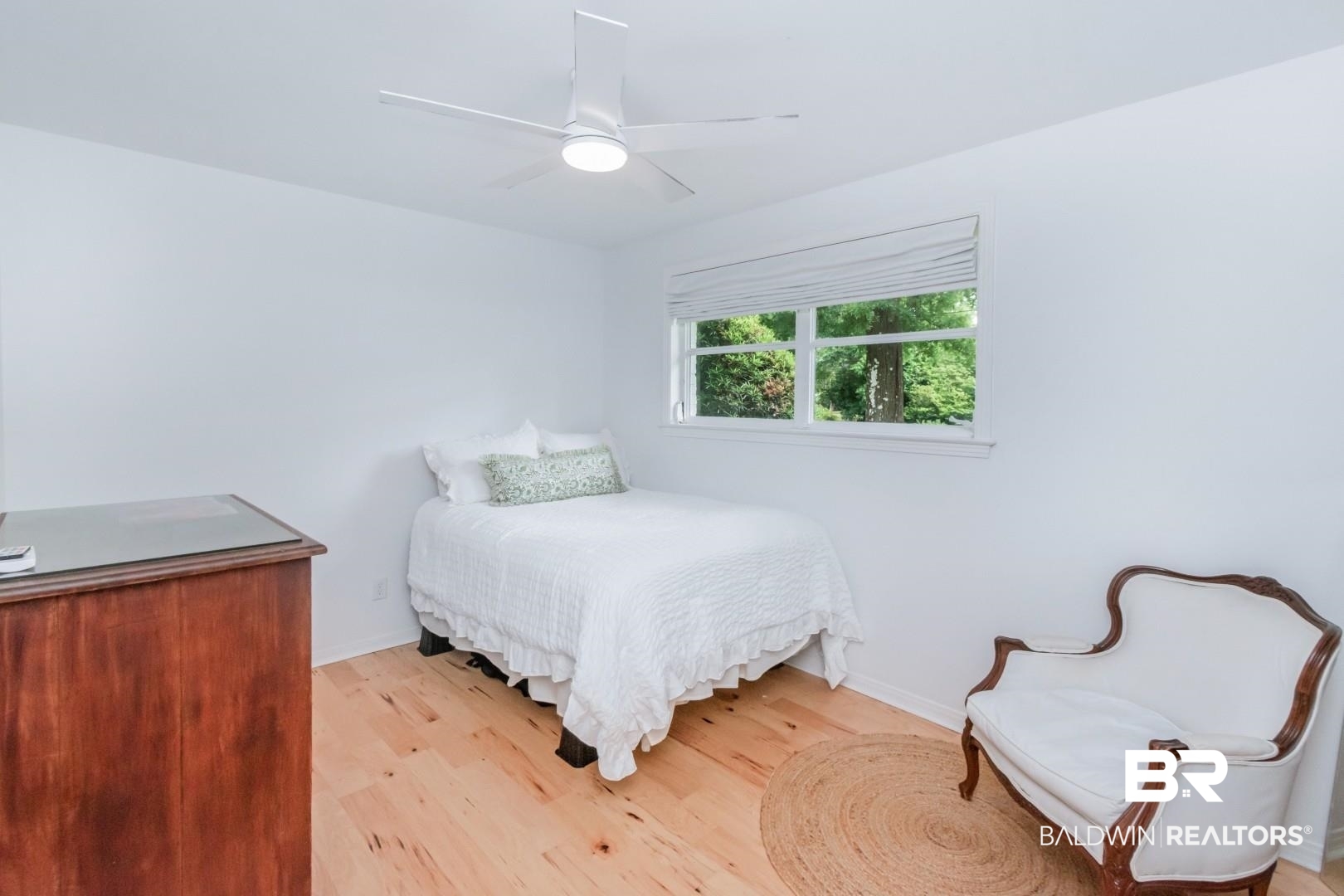 4596 Hawthorne Place Mobile, AL 36608 - Photo 16 of 34 Bright room featuring wood-finish flooring and a white ceiling fan