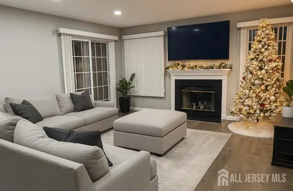 a living room with furniture a flat screen tv and a fireplace
