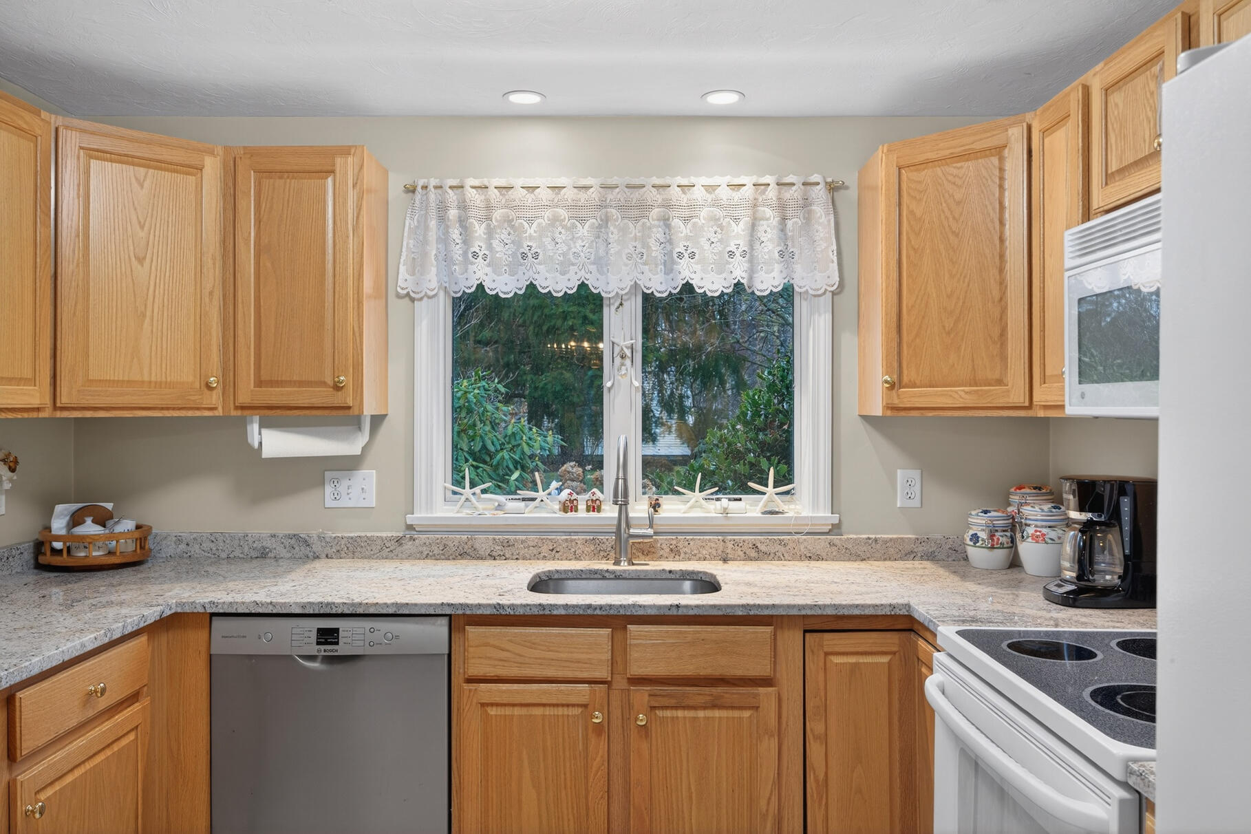 18 Windward Street, Unit 18 Mashpee, MA 02649 - Photo 15 of 34 a kitchen with stainless steel appliances granite countertop a sink a refrigerator and cabinets