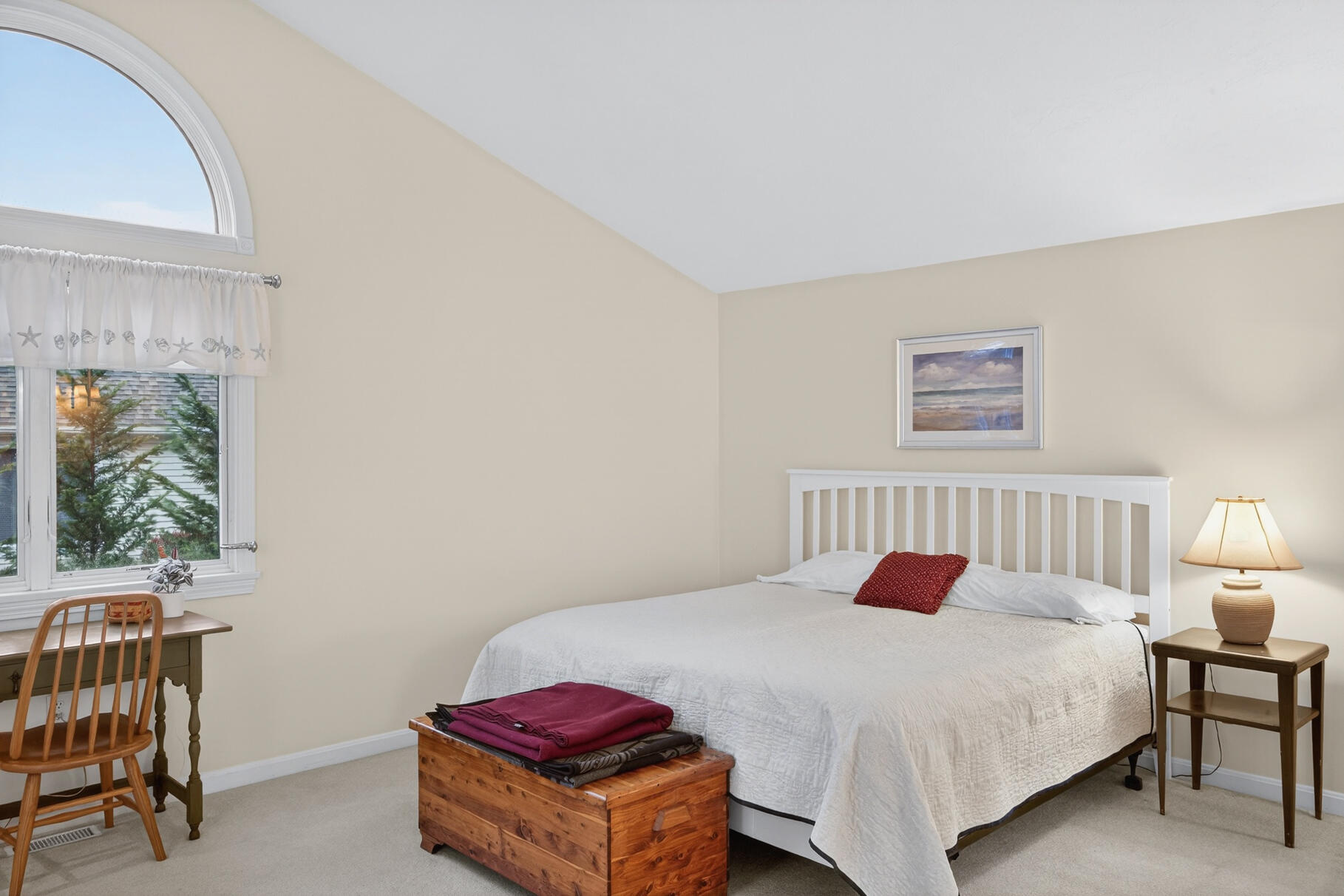 18 Windward Street, Unit 18 Mashpee, MA 02649 - Photo 19 of 34 a bedroom with a bed and a table