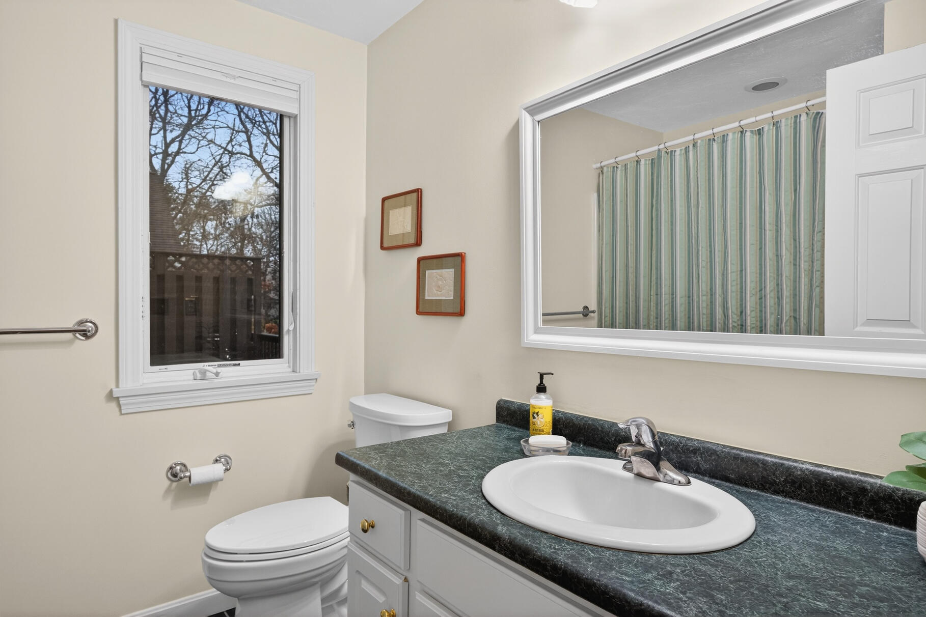 18 Windward Street, Unit 18 Mashpee, MA 02649 - Photo 22 of 34 a bathroom with a granite countertop sink toilet and mirror