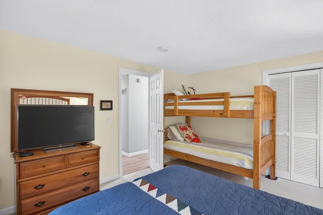 a bedroom with furniture and a flat screen tv