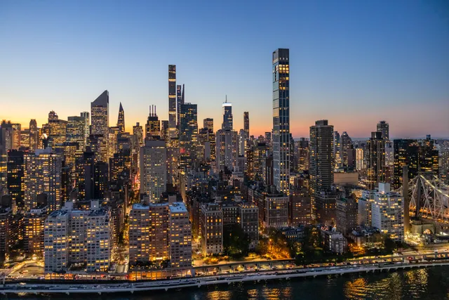 a spacious bedroom with a bed a couch and dresser