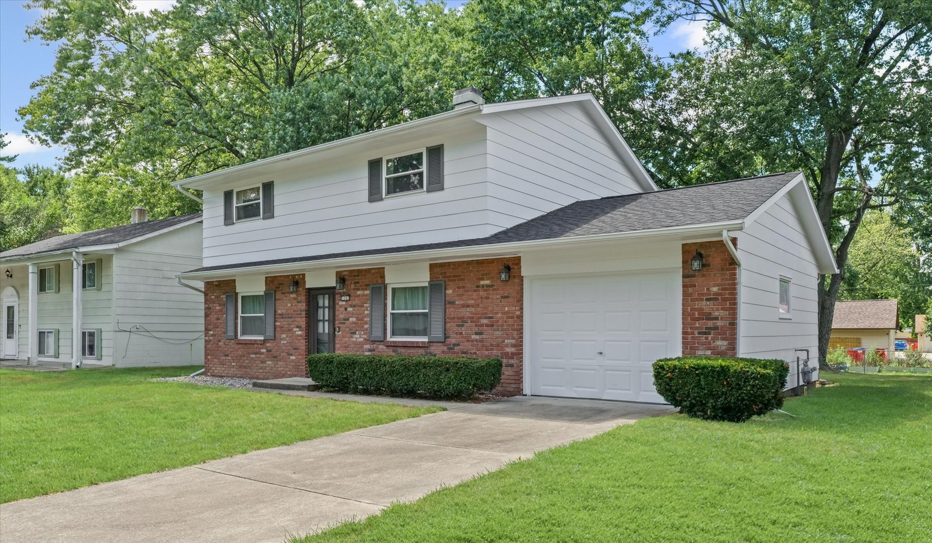 1007 Holiday Drive Champaign, IL 61821 - Photo 2 of 36 a front view of a house with a yard and green space