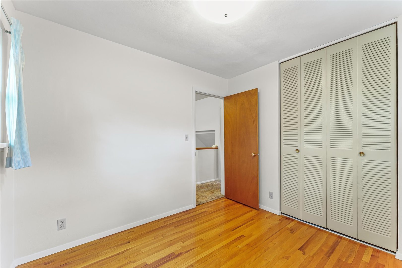 1007 Holiday Drive Champaign, IL 61821 - Photo 23 of 36 a view of an empty room with wooden floor