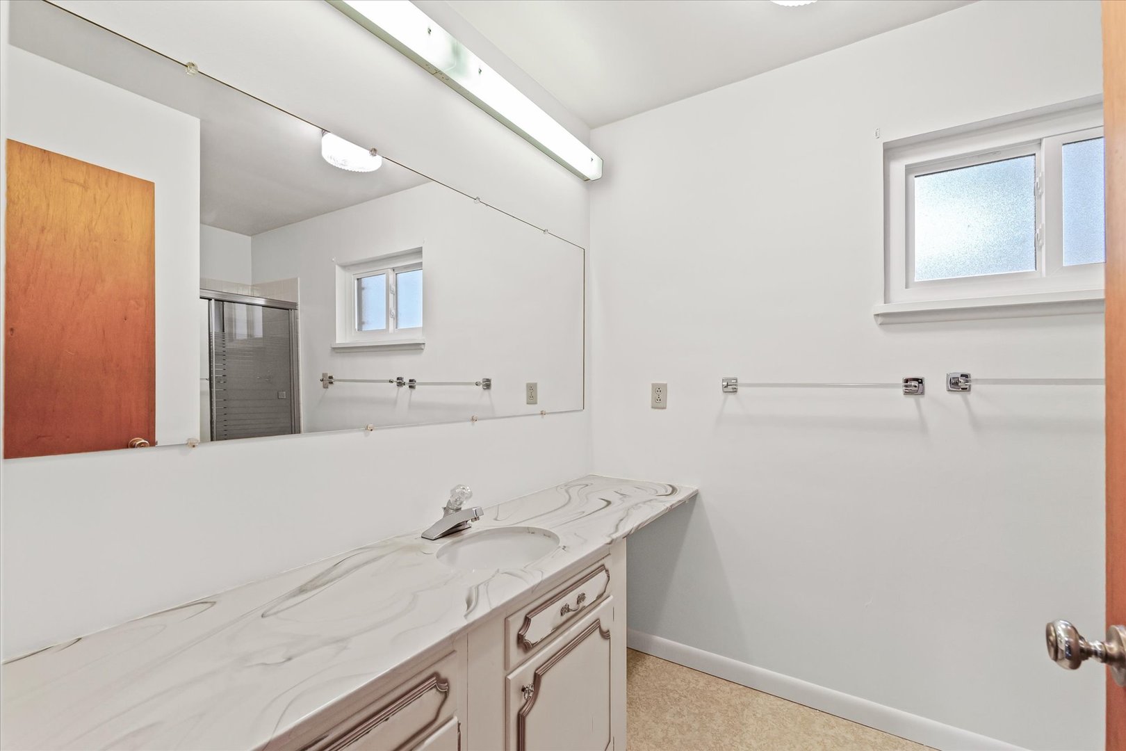 1007 Holiday Drive Champaign, IL 61821 - Photo 24 of 36 a bathroom with a sink and a mirror