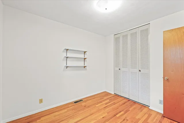 a view of a room with wooden floor and closet