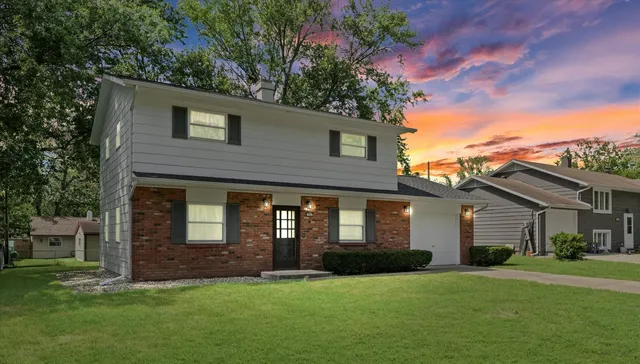 a front view of a house with a garden