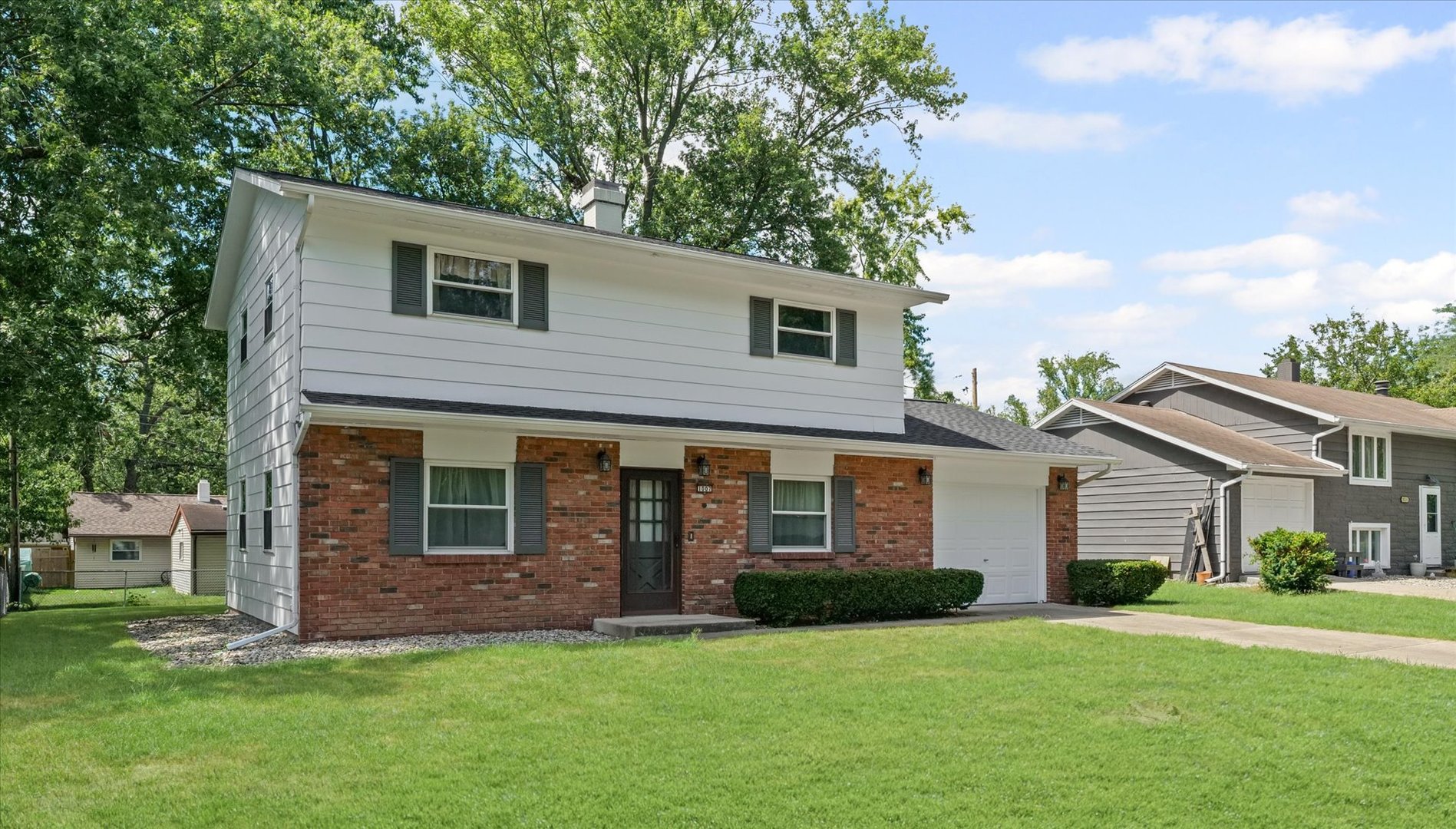1007 Holiday Drive Champaign, IL 61821 - Photo 5 of 36 a front view of a house with a garden
