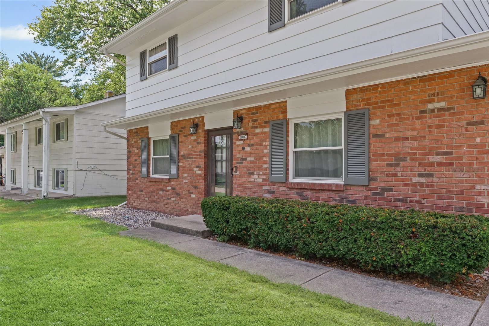 1007 Holiday Drive Champaign, IL 61821 - Photo 7 of 36 a front view of a house with a garden