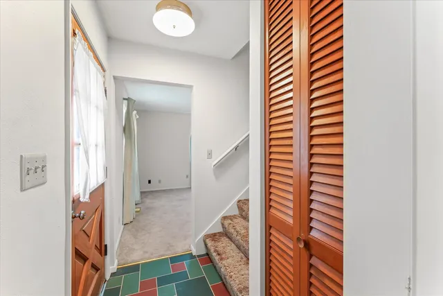 an empty room with closet and natural light
