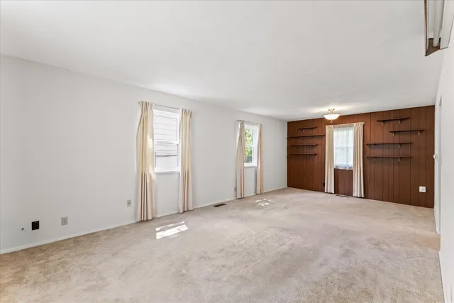 a view of an empty room with closet and closet