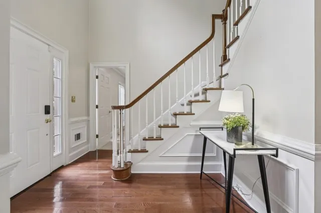 a view of entryway with wooden floor and stairs