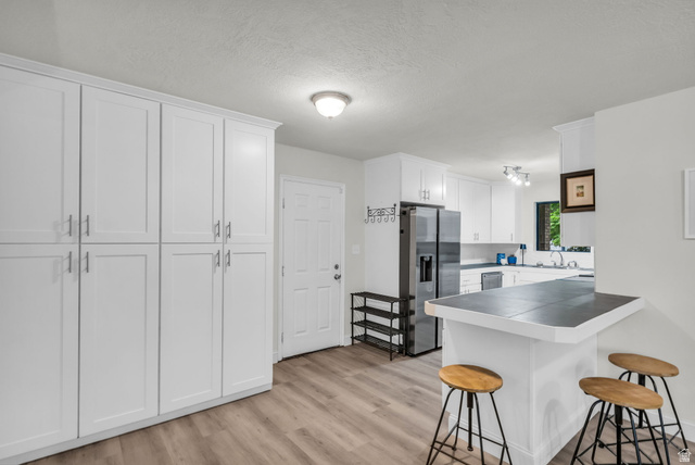 1539 East 450 South Springville, UT 84663 - Photo 10 of 49 Modern kitchen with white cabinetry and wood-finish flooring