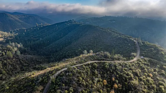 a view of a large mountain with a mountain in the background