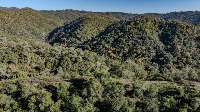 a view of a mountain range with a lush green hillside