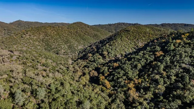 a view of a house with a mountain in the background