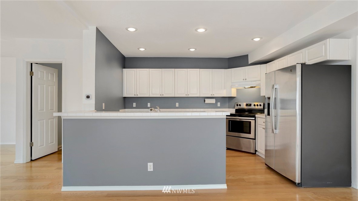 511 Redmond Place Northeast Renton, WA 98056 - Photo 11 of 31 a view of a kitchen with a sink and stainless steel appliances
