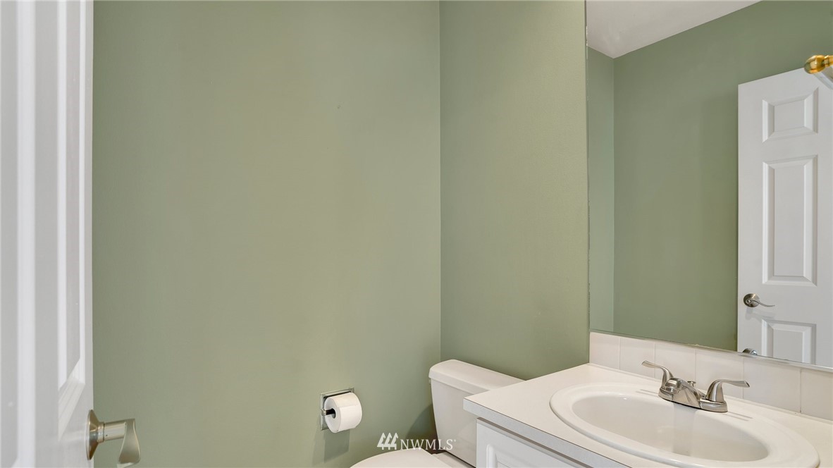 511 Redmond Place Northeast Renton, WA 98056 - Photo 15 of 31 a bathroom with a toilet sink vanity and mirror