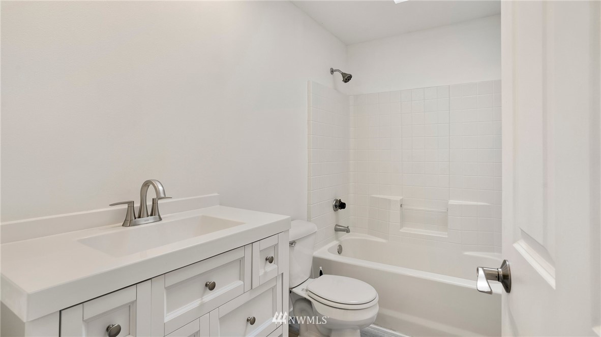 511 Redmond Place Northeast Renton, WA 98056 - Photo 19 of 31 a bathroom with a sink a toilet and shower