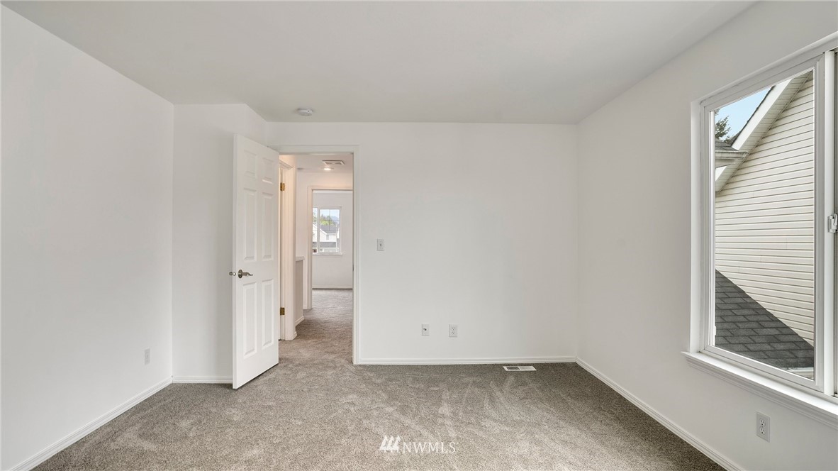 511 Redmond Place Northeast Renton, WA 98056 - Photo 22 of 31 an empty room with a window and a bathroom
