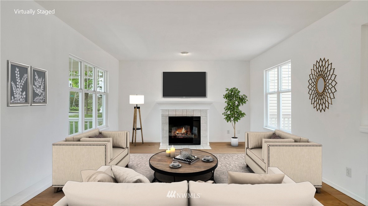 511 Redmond Place Northeast Renton, WA 98056 - Photo 4 of 31 a living room with furniture a fireplace and a large window