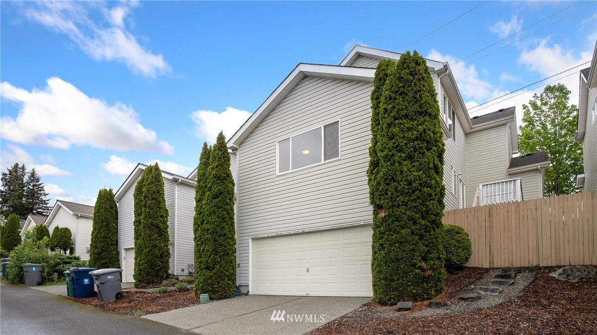511 Redmond Place Northeast Renton, WA 98056 - Photo 31 of 31 a view of a house with a yard and plants