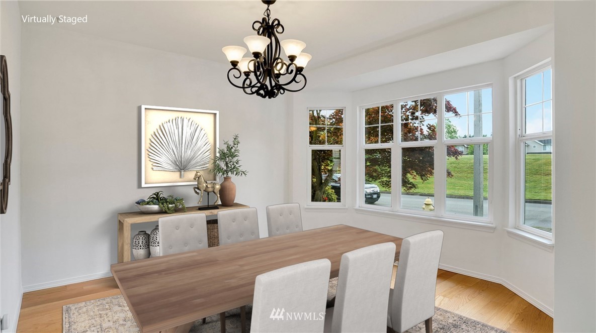 511 Redmond Place Northeast Renton, WA 98056 - Photo 6 of 31 a view of a dining room with furniture a chandelier and window