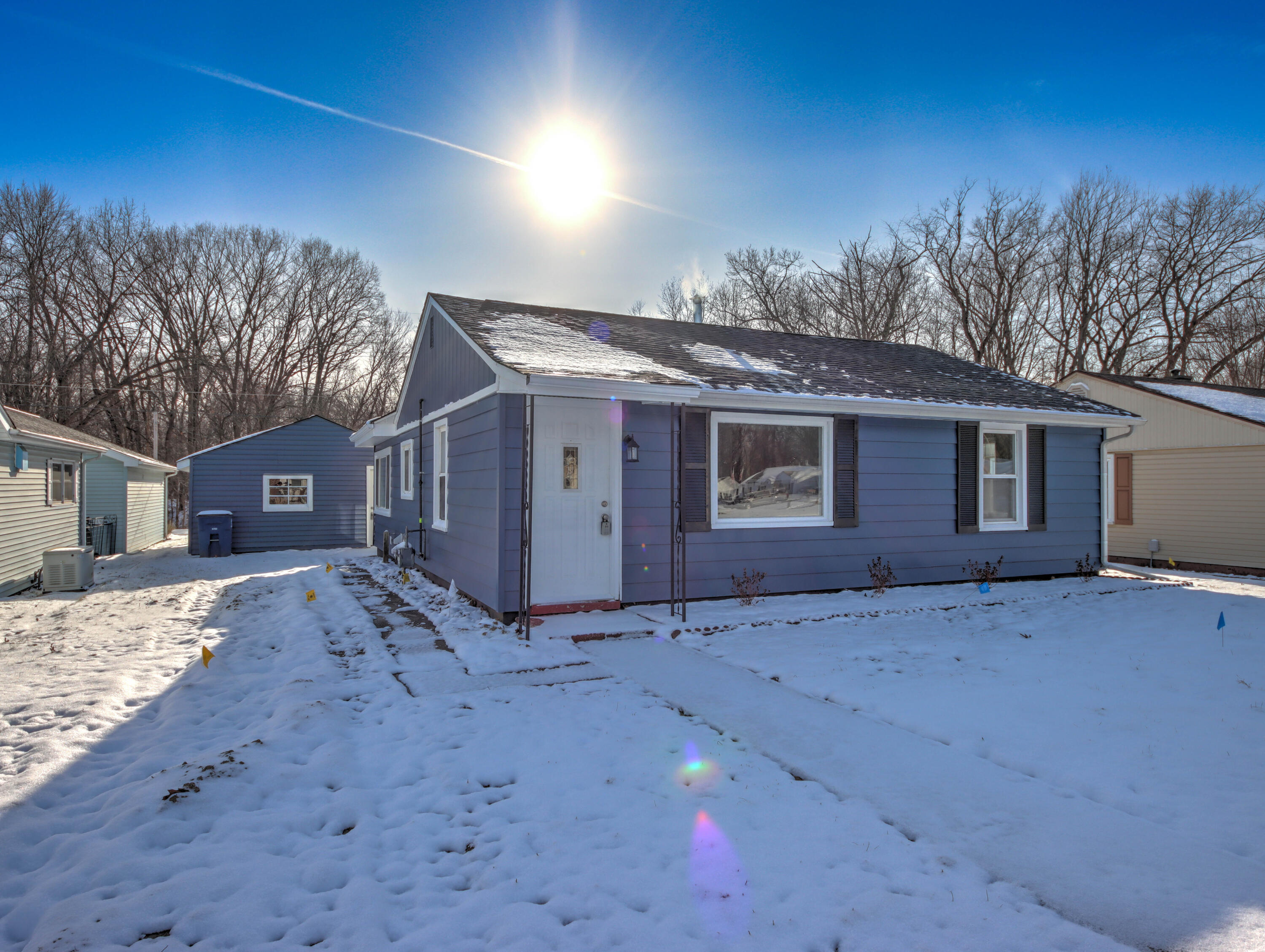 a view of a house with a snow in the background