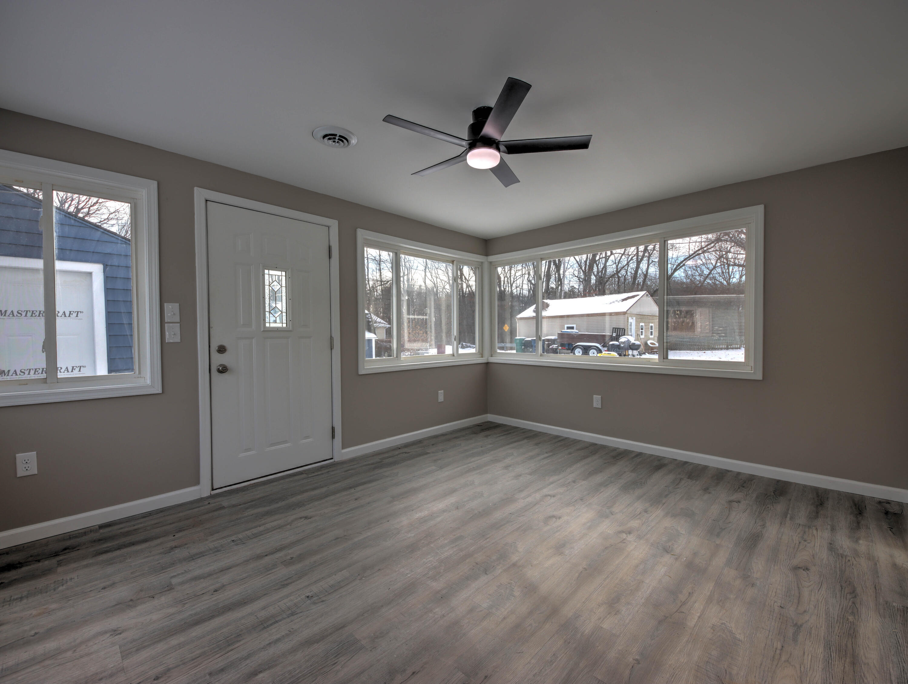 1663 Stone Lake Drive La Porte, IN 46350 - Photo 12 of 22 a view of an empty room with a window and wooden floor