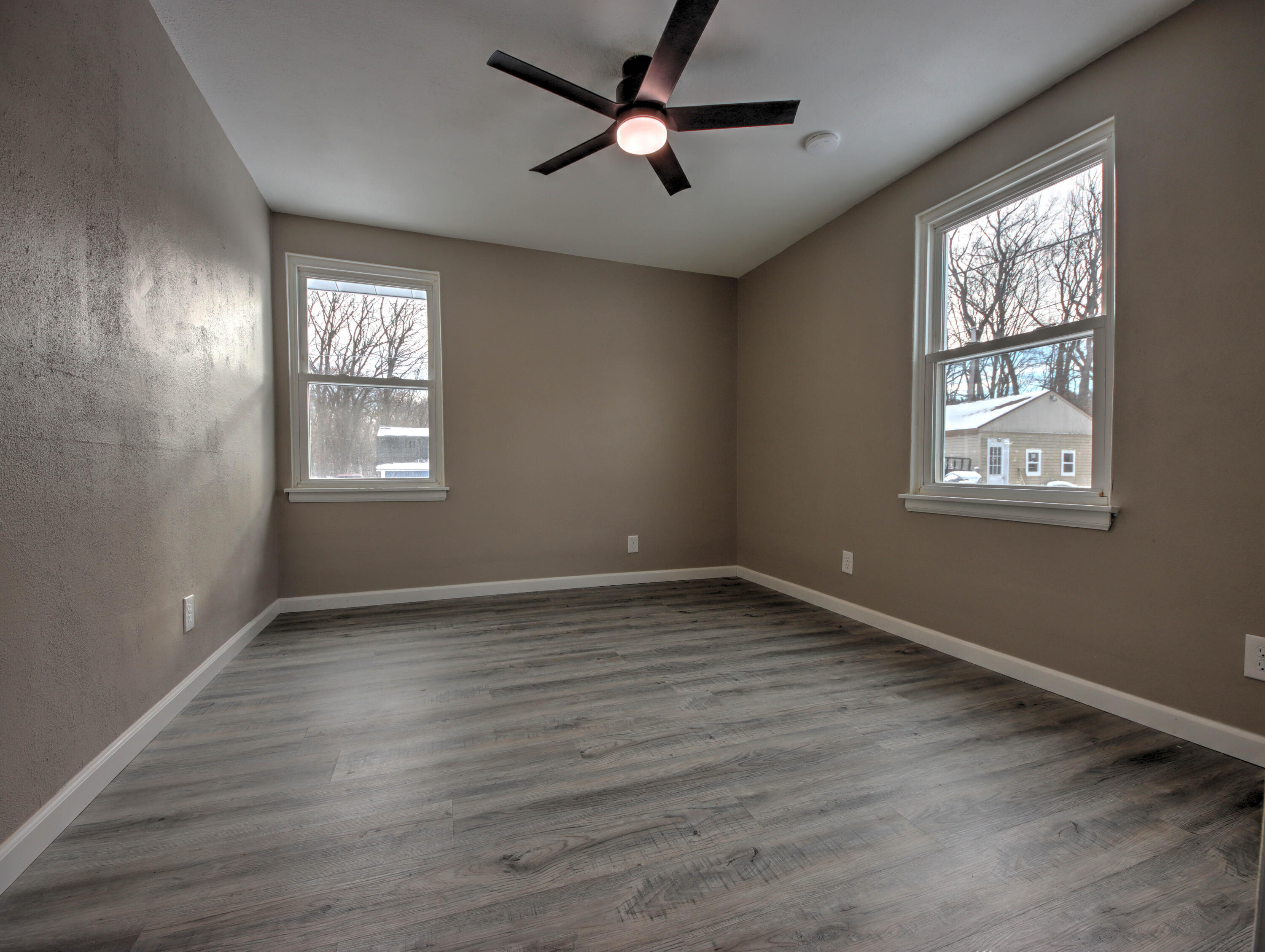 1663 Stone Lake Drive La Porte, IN 46350 - Photo 16 of 22 a view of an empty room with wooden floor and a window