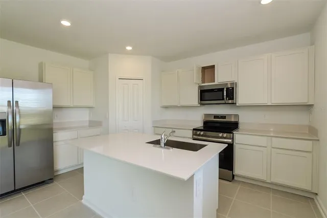 a view of a kitchen with a sink and a window