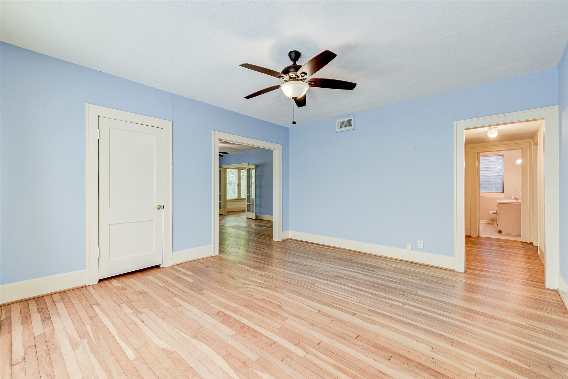 1737 Branard Street, Unit 1 Houston, TX 77098 - Photo 16 of 21 a view of empty room with wooden floor and ceiling fan