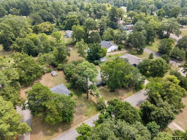 an aerial view of a house with a yard