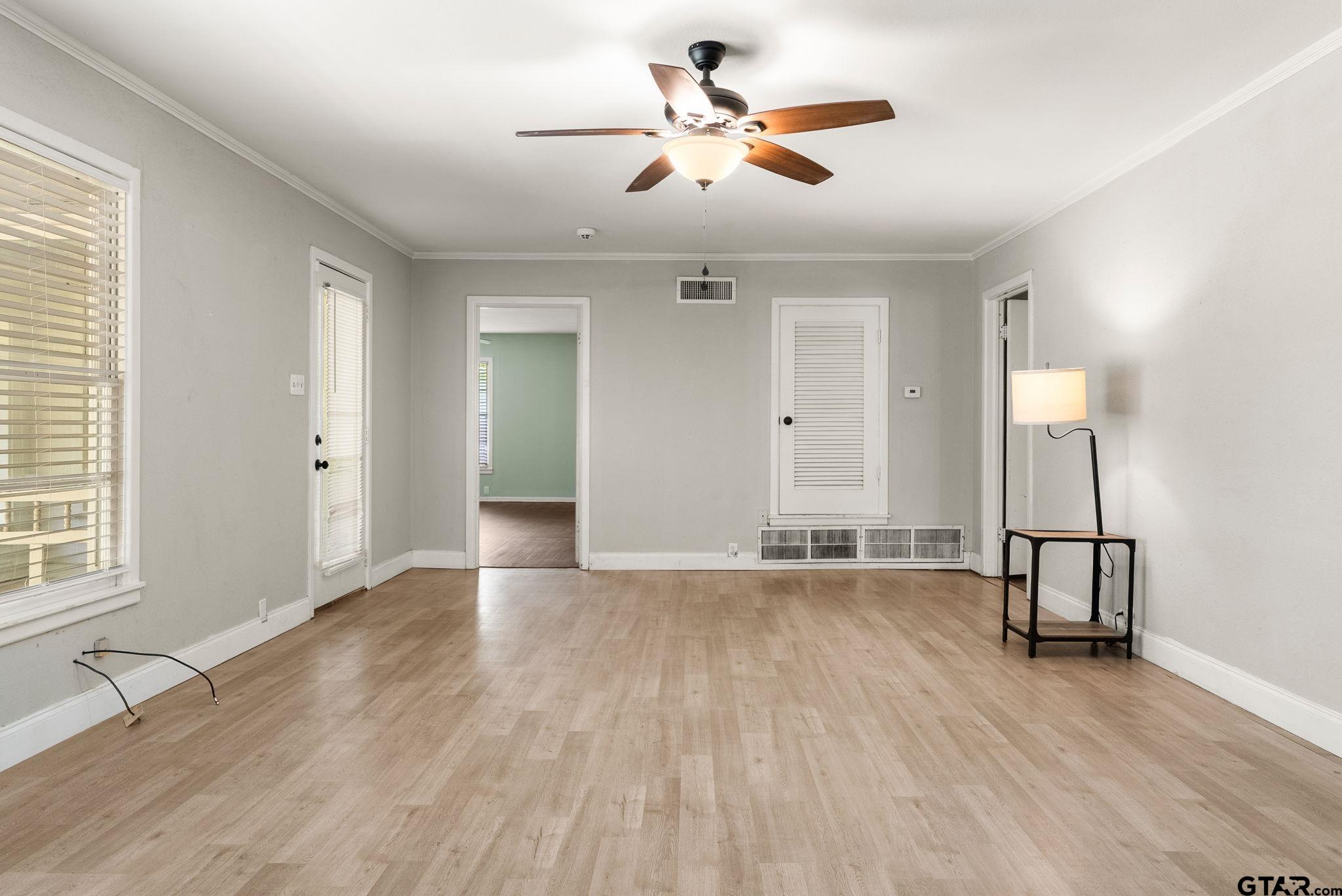150 Wightman Lane Rusk, TX 75785 - Photo 6 of 38 an empty room with wooden floor and windows