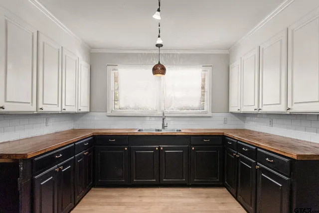 a kitchen with stainless steel appliances granite countertop a sink and dishwasher with wooden cabinets